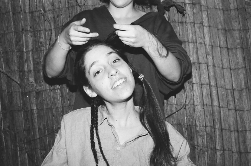 Evie plaiting Mimi's hair.