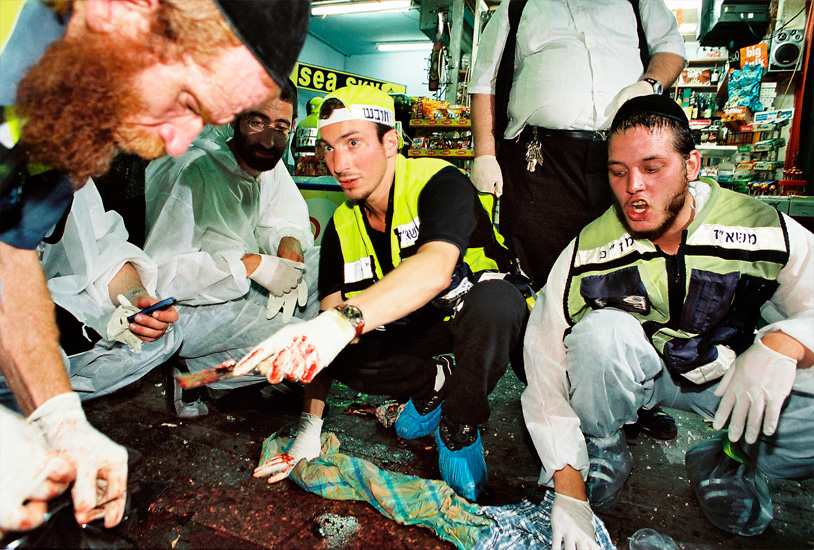 Shlomo Bloch & colleagues collecting human debris from bomb scene.